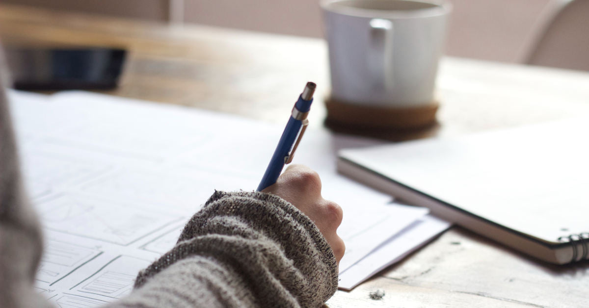 Woman writing on paper
